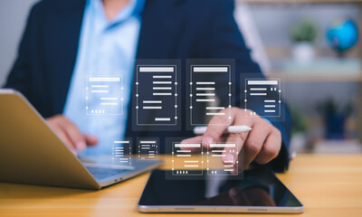 Document management visualized by a person interacting with holographic icons from a tablet, with laptop in background, symbolizing digital workflow, remote work, and paperless efficiency.