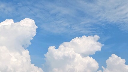 White clouds scattered across the blue sky with daylight natural background. Blue sky with clouds....