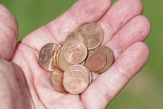 Euro cent coins currency of the European Union in a hand. One, two and five cent. Netherlands.