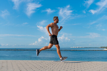 Healthy lifestyle. Sportsman running in summer. Sport runner do workout. Sport lifestyle with...