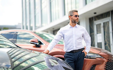 Rich Hispanic business man expressing success. Luxury business. Rich man near expensive car. Luxury...