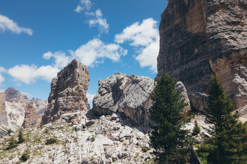 Majestic rock formations rise towards a brilliant blue sky in the stunning Dolomites.