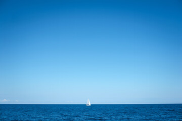 Solitary Sailboat on a Calm Ocean