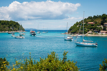 Tranquil Bay with Sailboats and Lush Hills