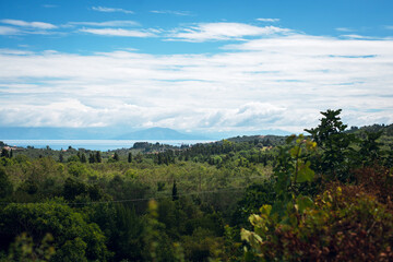 Scenic Hills and Sea Under Cloudy Sky