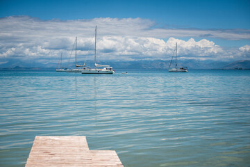 Sailboats on a Calm Ocean from Pier View