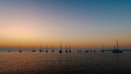 Sunset Silhouettes of Sailboats on the Sea