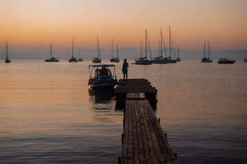 Serene Sunset Over Sailboats and Pier