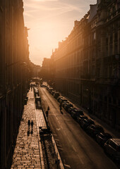 Hazy warm sunrise on residential street in Paris, France.