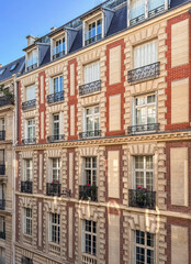 Traditional residential building with iron balconies in Paris, France.