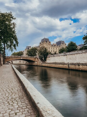 Cobblestone walkway along bank of the River Seine in Paris, France.