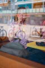 Teenage girl drinking juice in restaurant