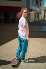 Young teenage girl riding skateboard