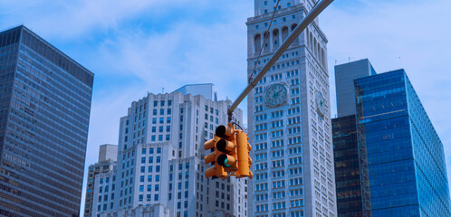 skyscrapers in downtown New York City yellow traffic light