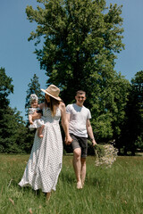 Young family walking barefoot with baby outdoors