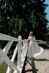 Barefoot woman walking on wooden bridge in park