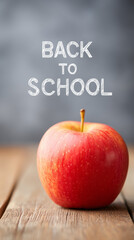 The white text "back to school" on the black blackboard. An apple, colored pencils on a blackboard background.
