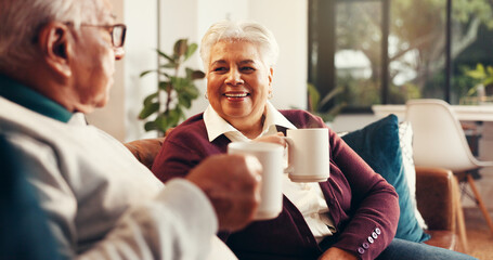 Coffee, happy and senior couple on sofa in home with conversation, bonding or laughing together. Relax, cappuccino and elderly man with woman for retirement in living room for calm morning in house.