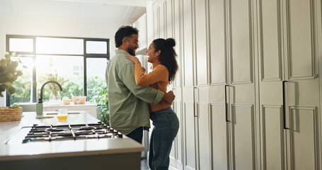 Laughing, couple and hug in kitchen, love or bonding on break in house, commitment or relationship....