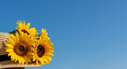 straw hat decorated with sunflowers and blue sky