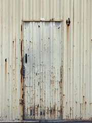 metal door of a deteriorated industrial warehouse