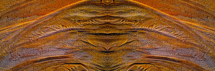 close-up of a textured multicolored sand surface. The image is highly detailed, with varying shades...