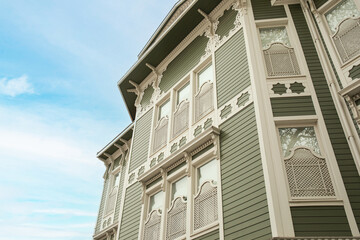 Historic building showcases detailed woodwork and a clear sky