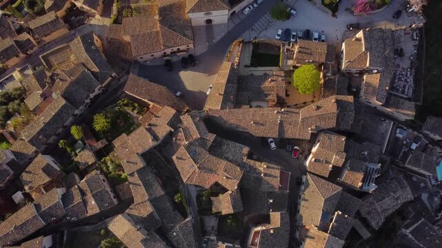 Aerial downward view of Spello rooftops bathed in golden hour light, Umbria, 4K
