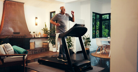 Senior, happy man and running with headphones on treadmill in home for fitness, workout or...