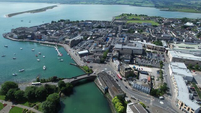 traffic flowing over bridge into Dungarvan town with Dungarvan Bay and Harbour busy Waterford Town in Ireland on a bright Summer Day
