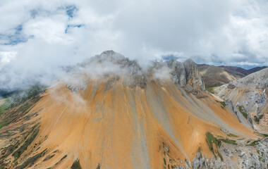 Panoramic View of Baima Snow Mountain's Dolomites shrouded in mist and clouds
