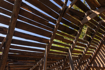 A close-up view of a rustic wooden structure showing the exposed beams