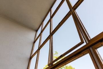 Wooden window frames with clear glass panes on a sunny day