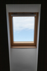 Background photo of a skylight showing blue sky and minimalist interior design