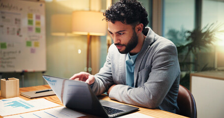 Man, reading and laptop in office at night of accounting, finance report and budget review. Accountant, pc or taxes audit of revenue policy, financial information and investment feedback of deadline