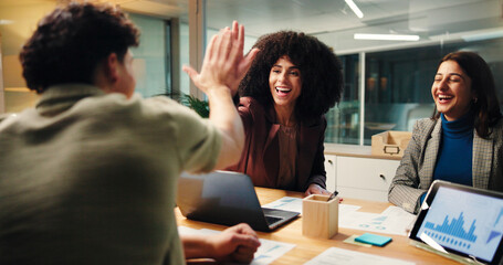 Happy, people and high five in office at night of good news, celebration and finance growth. Staff,...