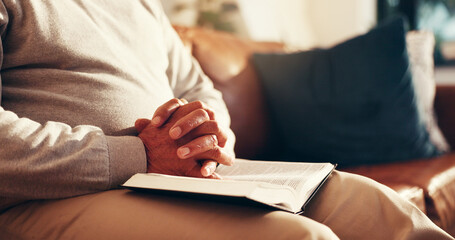 Worship, hands and bible with man on sofa for prayer, gratitude and peace. Religion, spiritual...