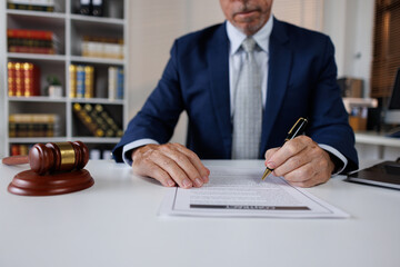 Judge or Legal advisor lawyer examining and signing legal documents. 
Lawyer singing in documents,...