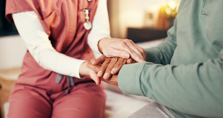 Caregiver, senior man and holding hands in home for medical service, empathy and compassion. Assisted living, night and nurse with comfort to elderly patient on bed for healthcare support and bonding © peopleimages.com