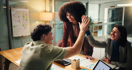 People, meeting and high five in office at night for good news, celebration and finance growth....