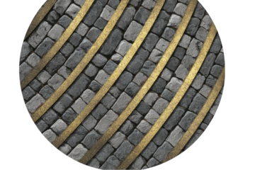 Circular overhead shot of a cobblestone pavement interspersed with diagonal metallic strips.  The stones are grey and the metal is gold