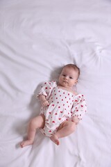 Cute newborn baby lying on bed, top view