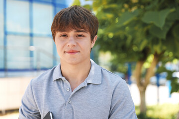 Portrait of cute teenage boy on city street