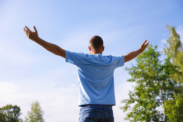 Feeling freedom. Man enjoying time outdoors, back view