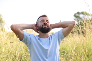 Feeling freedom. Happy man enjoying time outdoors