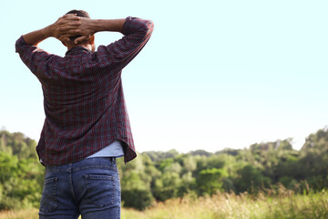 Feeling freedom. Man enjoying time outdoors, back view. Space for text