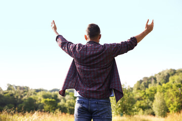 Feeling freedom. Man enjoying time outdoors, back view