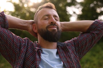 Feeling freedom. Happy man enjoying time outdoors