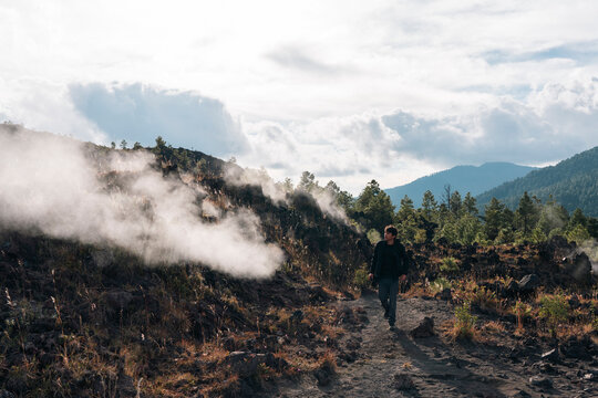 One man walking on a trail next to fumaroles of Paricutin volcano