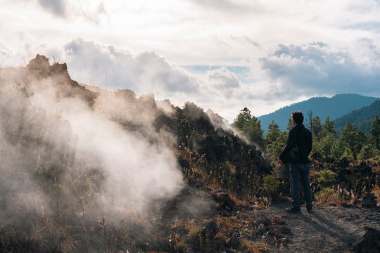 One man stands next to fumaroles of Paricutin volcano